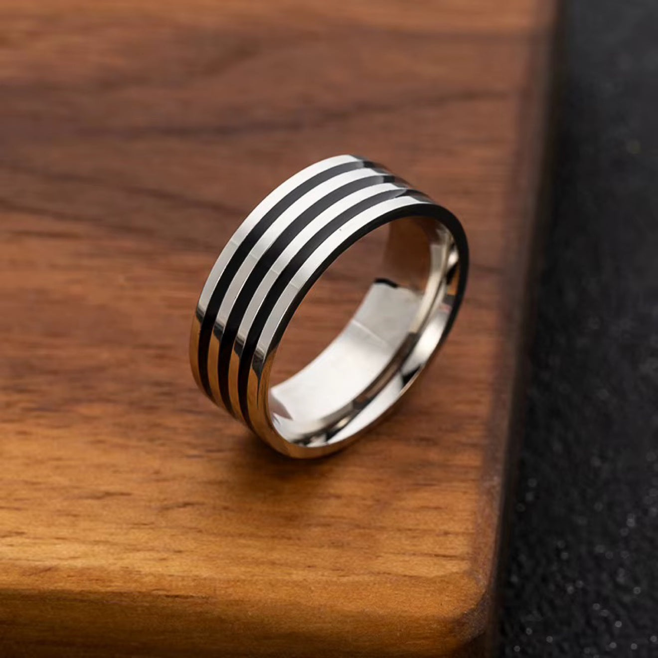 Black Enamel Lines Band Ring in silver on wood