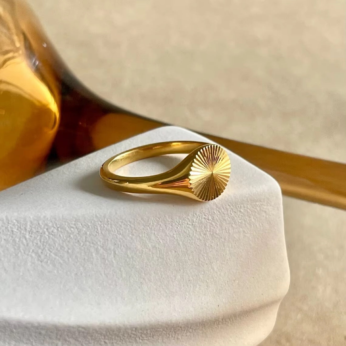 Sunburst Signet Ring in gold on stand